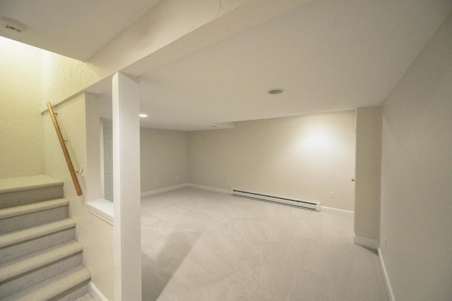 basement with a baseboard radiator and carpet flooring