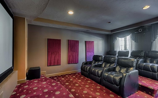 cinema featuring a tray ceiling and carpet flooring