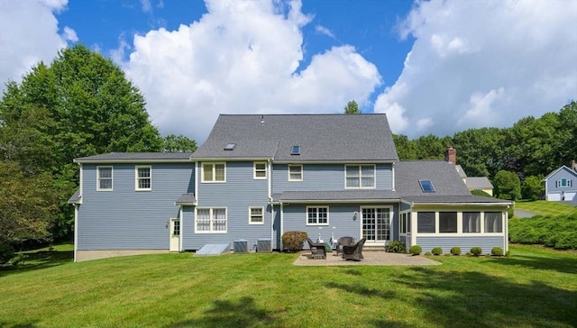 rear view of house with a yard, a sunroom, a patio, and central air condition unit