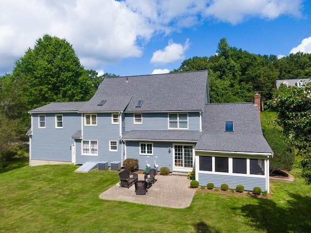 back of property featuring a yard, a patio area, and central AC