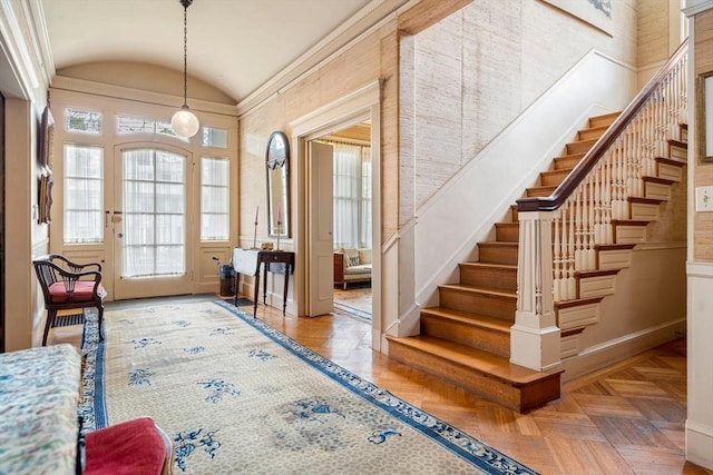 entrance foyer with high vaulted ceiling and parquet floors