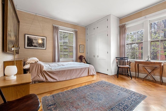 bedroom featuring a closet and light parquet floors