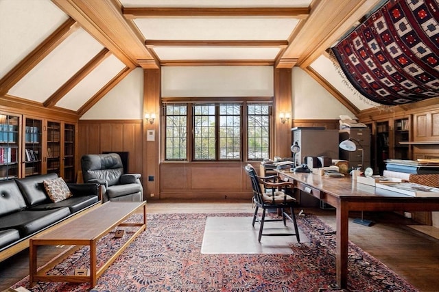 home office with wooden walls, vaulted ceiling with beams, and hardwood / wood-style flooring