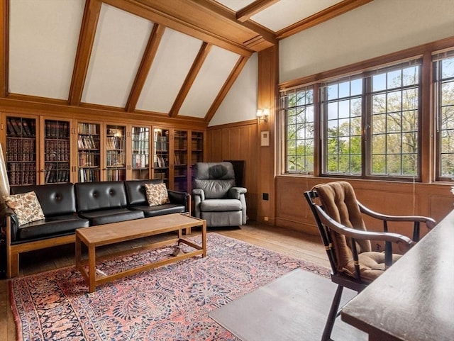 interior space featuring hardwood / wood-style floors, wooden walls, high vaulted ceiling, and beamed ceiling