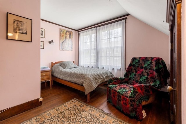 bedroom with vaulted ceiling and wood-type flooring