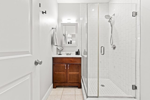 bathroom with tile patterned floors, vanity, and an enclosed shower