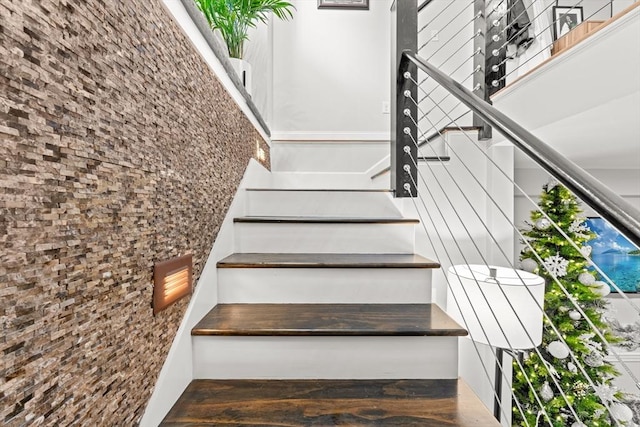 stairs featuring wood-type flooring