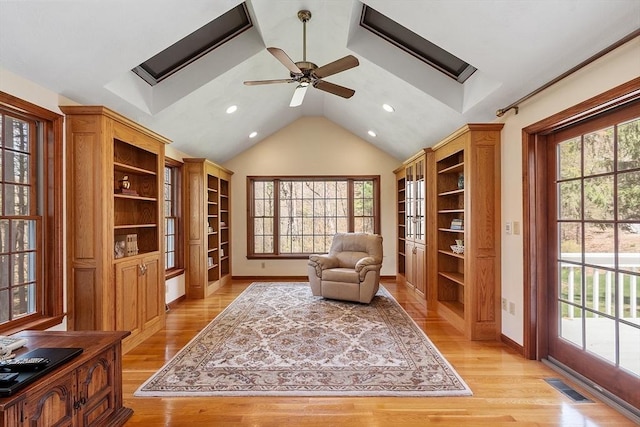 sitting room with a ceiling fan, visible vents, lofted ceiling, recessed lighting, and light wood-style flooring