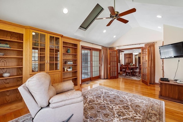 living room featuring recessed lighting, ceiling fan, vaulted ceiling, and light wood-type flooring
