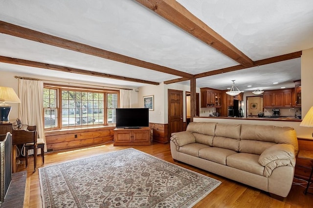 living area featuring recessed lighting, a wainscoted wall, light wood finished floors, and beam ceiling
