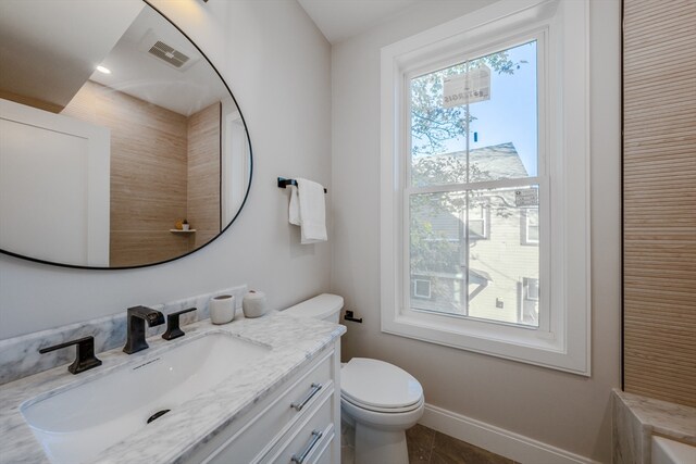 bathroom featuring tile patterned floors, vanity, and toilet