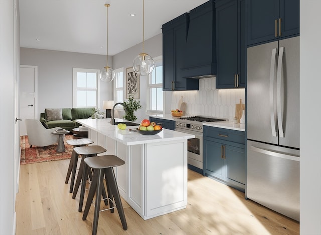 kitchen featuring blue cabinetry, light wood-type flooring, stainless steel appliances, and sink