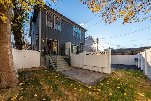 back of house featuring a yard