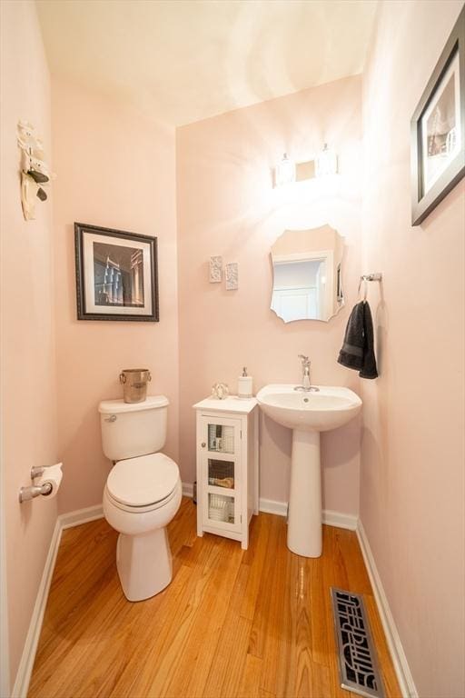 23 Kendall Ct Unit 23, Bedford, MA 01730 - bathroom with toilet, wood finished floors, baseboards, and visible vents