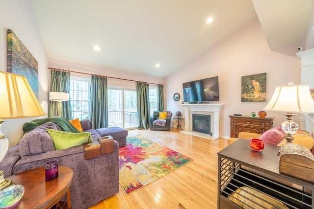 23 Kendall Ct Unit 23, Bedford, MA 01730 - living room featuring recessed lighting, high vaulted ceiling, wood finished floors, and a glass covered fireplace