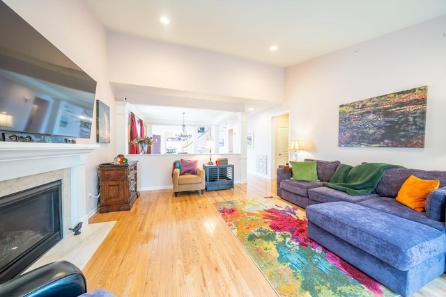 23 Kendall Ct Unit 23, Bedford, MA 01730 - living area featuring a premium fireplace, wood finished floors, a notable chandelier, and recessed lighting