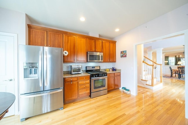 23 Kendall Ct Unit 23, Bedford, MA 01730 - kitchen with stainless steel appliances, brown cabinets, and decorative columns
