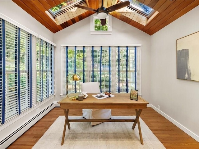 office featuring baseboard heating, plenty of natural light, and hardwood / wood-style floors