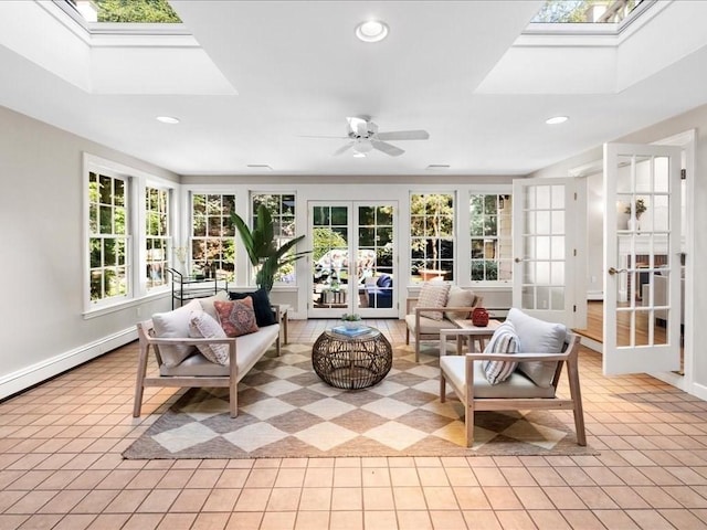 sunroom with a baseboard heating unit, a skylight, french doors, and ceiling fan