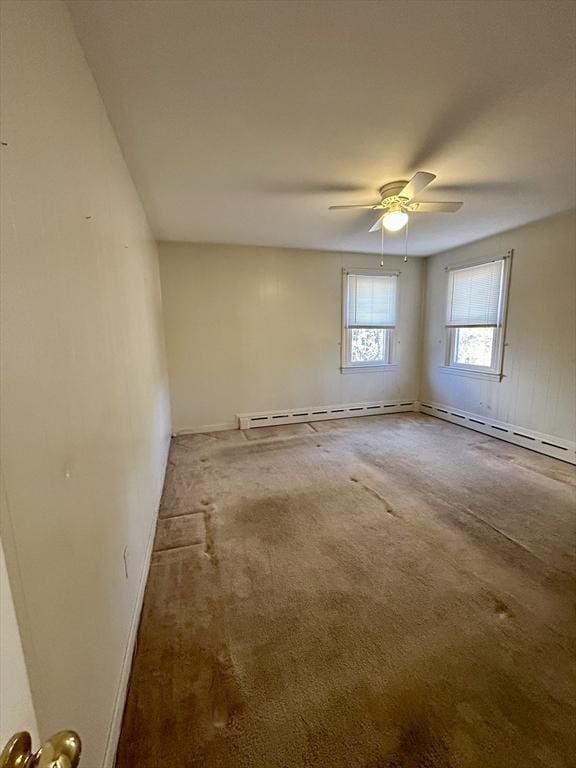 spare room featuring ceiling fan and carpet