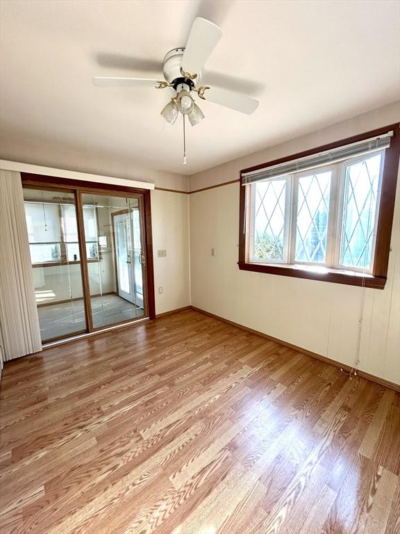 unfurnished room featuring ceiling fan, light wood-type flooring, and french doors