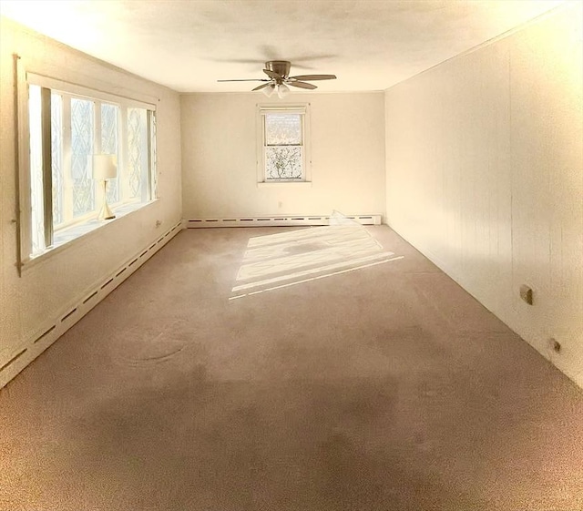 spare room featuring ceiling fan, a baseboard radiator, and carpet flooring