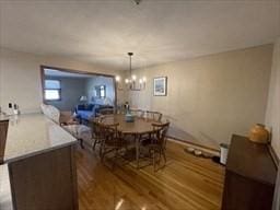 dining space featuring a chandelier and wood finished floors
