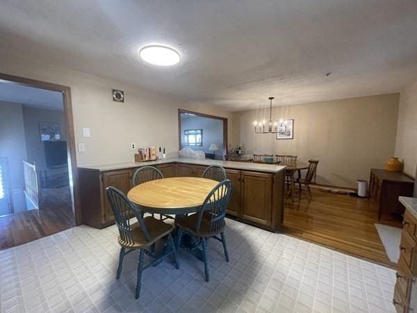 dining room featuring a notable chandelier and light wood-style floors