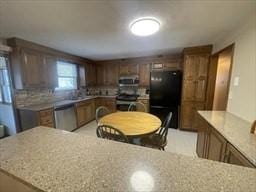 kitchen featuring freestanding refrigerator, stove, and dishwasher