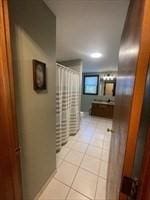 hallway featuring light tile patterned flooring