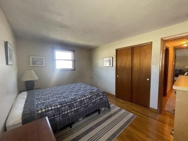 bedroom with a closet and wood finished floors