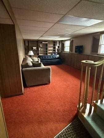interior space featuring wood walls and carpet