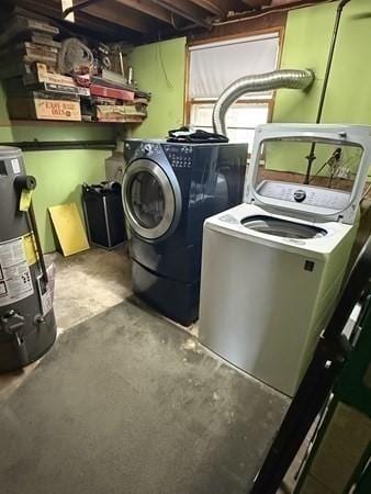 clothes washing area with laundry area, washer and clothes dryer, and water heater