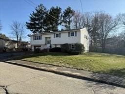 raised ranch with a front yard