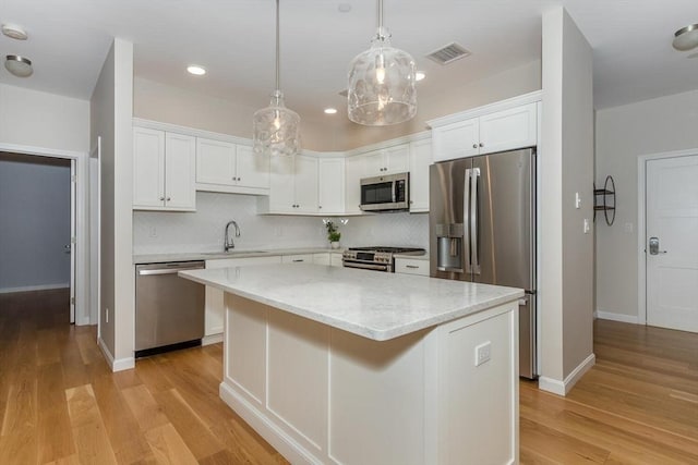 1 Revolution Way Unit 108, Canton, MA 02021 - kitchen with appliances with stainless steel finishes, white cabinetry, tasteful backsplash, and recessed lighting