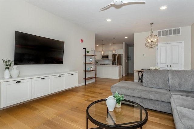 1 Revolution Way Unit 108, Canton, MA 02021 - living area with light wood finished floors, ceiling fan, a chandelier, and recessed lighting