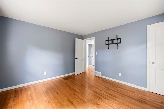 spare room featuring light hardwood / wood-style floors