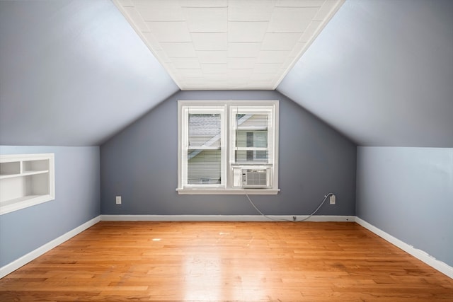 bonus room featuring vaulted ceiling, cooling unit, and wood-type flooring