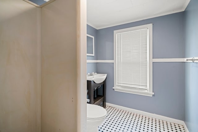 bathroom featuring crown molding, toilet, and tile patterned flooring