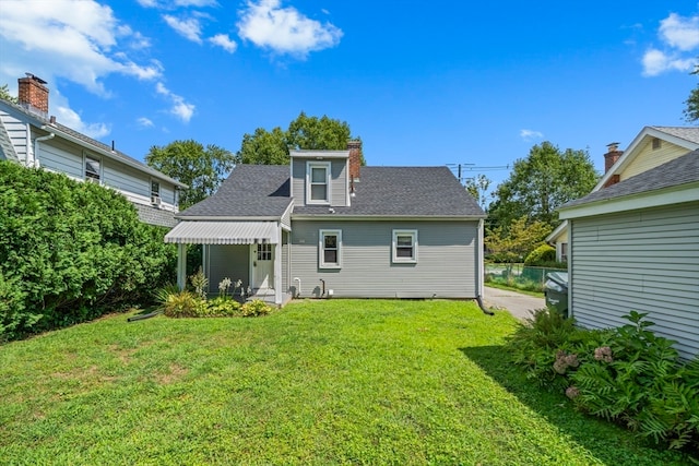 back of house with a yard