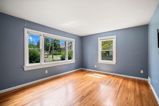 spare room with light hardwood / wood-style flooring