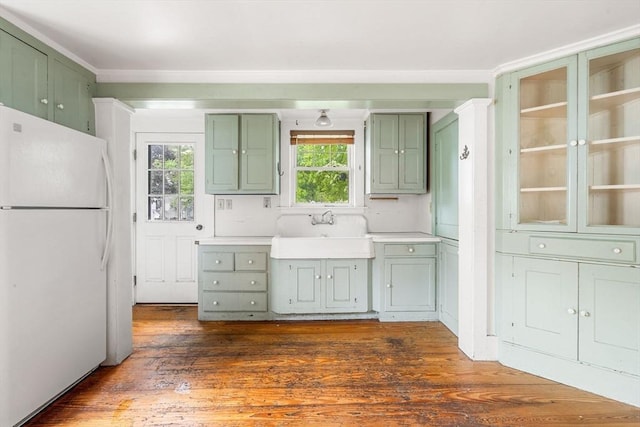 21 Chapel St Unit 21, Newburyport, MA 01950 - kitchen with freestanding refrigerator, green cabinets, dark wood-type flooring, light countertops, and crown molding
