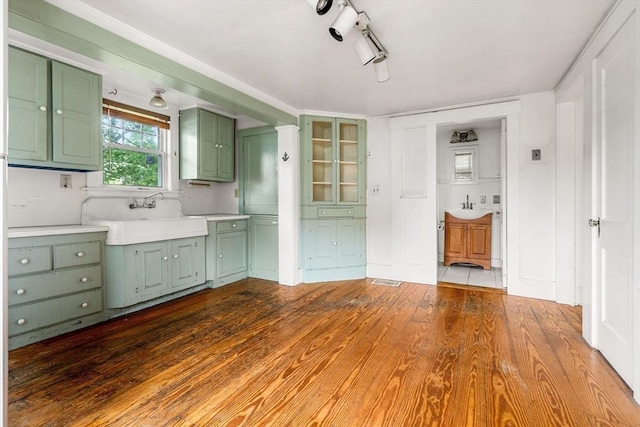 21 Chapel St Unit 21, Newburyport, MA 01950 - kitchen featuring green cabinetry, dark wood-style flooring, and light countertops