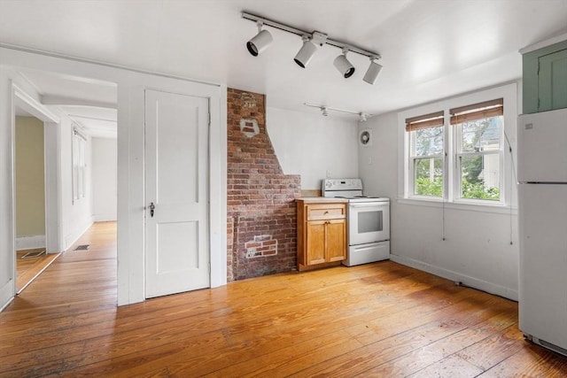 21 Chapel St Unit 21, Newburyport, MA 01950 - kitchen featuring white appliances, light wood-type flooring, track lighting, and light countertops