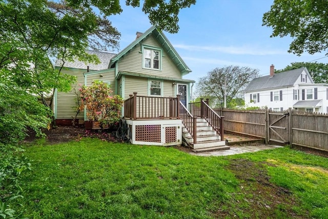 21 Chapel St Unit 21, Newburyport, MA 01950 - rear view of property featuring a fenced backyard, a chimney, and a gate