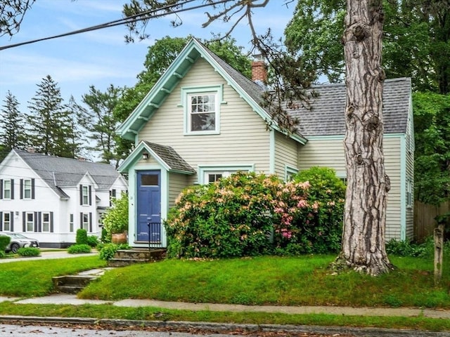 21 Chapel St Unit 21, Newburyport, MA 01950 - view of front of house with roof with shingles, a chimney, and a front yard