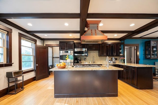 272 County St, Seekonk, MA 02771 - kitchen with appliances with stainless steel finishes, island range hood, light wood-style floors, beamed ceiling, and dark brown cabinets