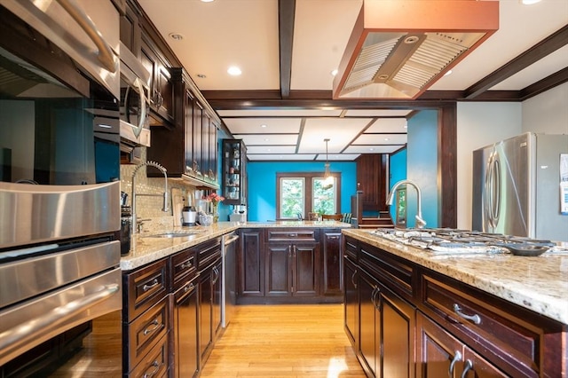 272 County St, Seekonk, MA 02771 - kitchen with a sink, stainless steel appliances, light wood finished floors, backsplash, and light stone countertops