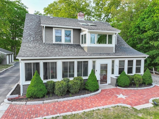 272 County St, Seekonk, MA 02771 - view of front of home featuring a chimney, roof with shingles, and a sunroom
