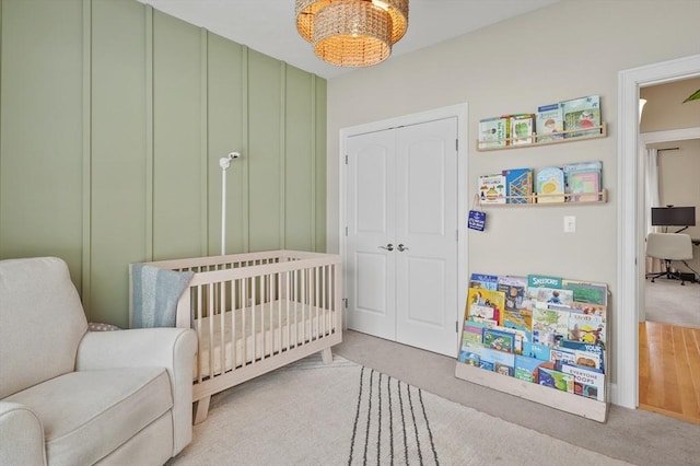 80 Edgemere Ave Unit 80, Northbridge, MA 01588 - bedroom featuring carpet floors, a crib, a closet, and a chandelier